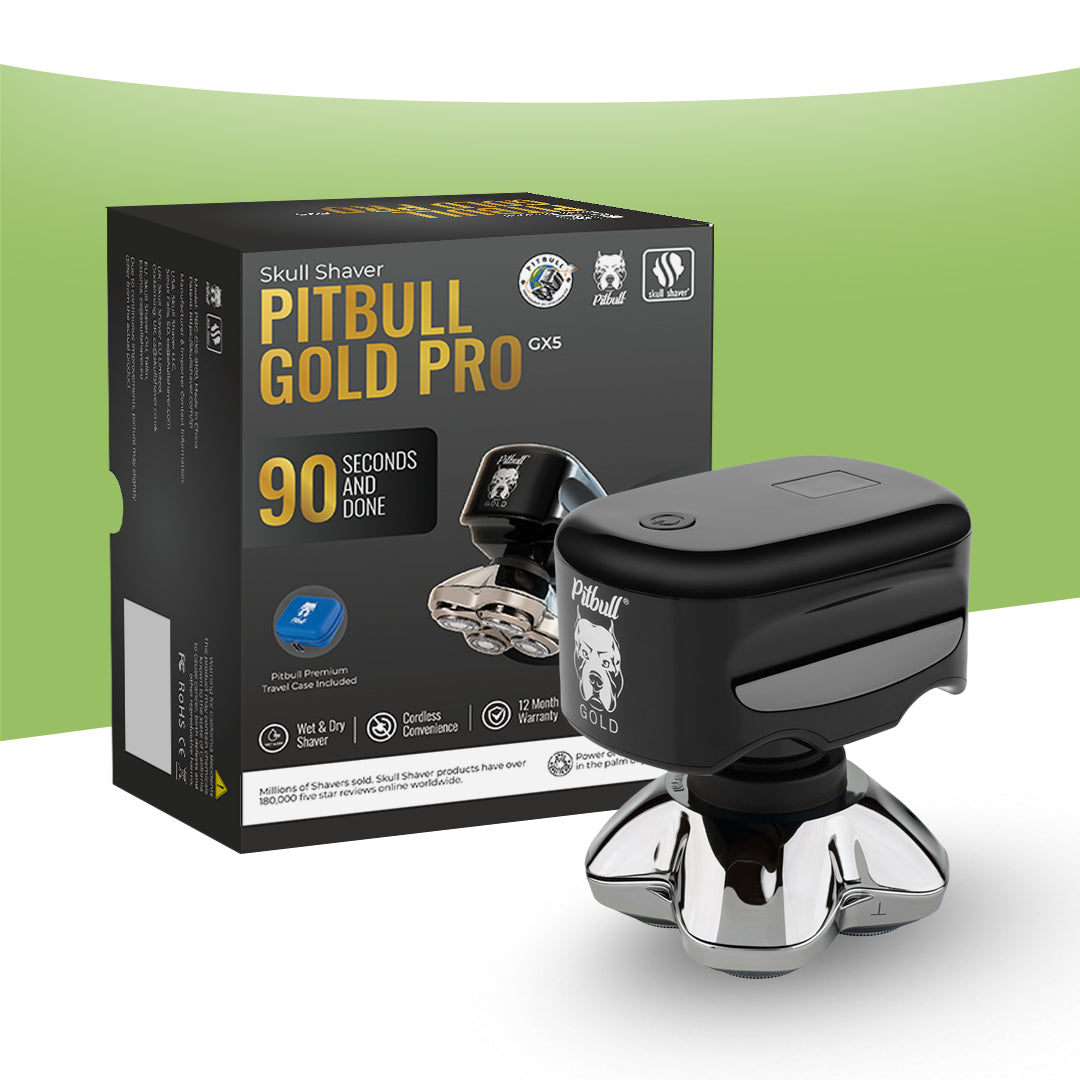 A black and silver Skull Shaver Pitbull Gold Pro GX5 electric skull shaver shown next to its black retail box on a white and light green background.