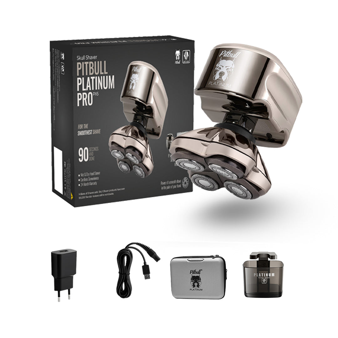 Pitbull Platinum Pro GX5 shaver shown with its retail box, two metallic silver shaving heads, a wall charger, a USB cable, a grey Deluxe Travel case, and a Platinum Rinse Stand on a white background.