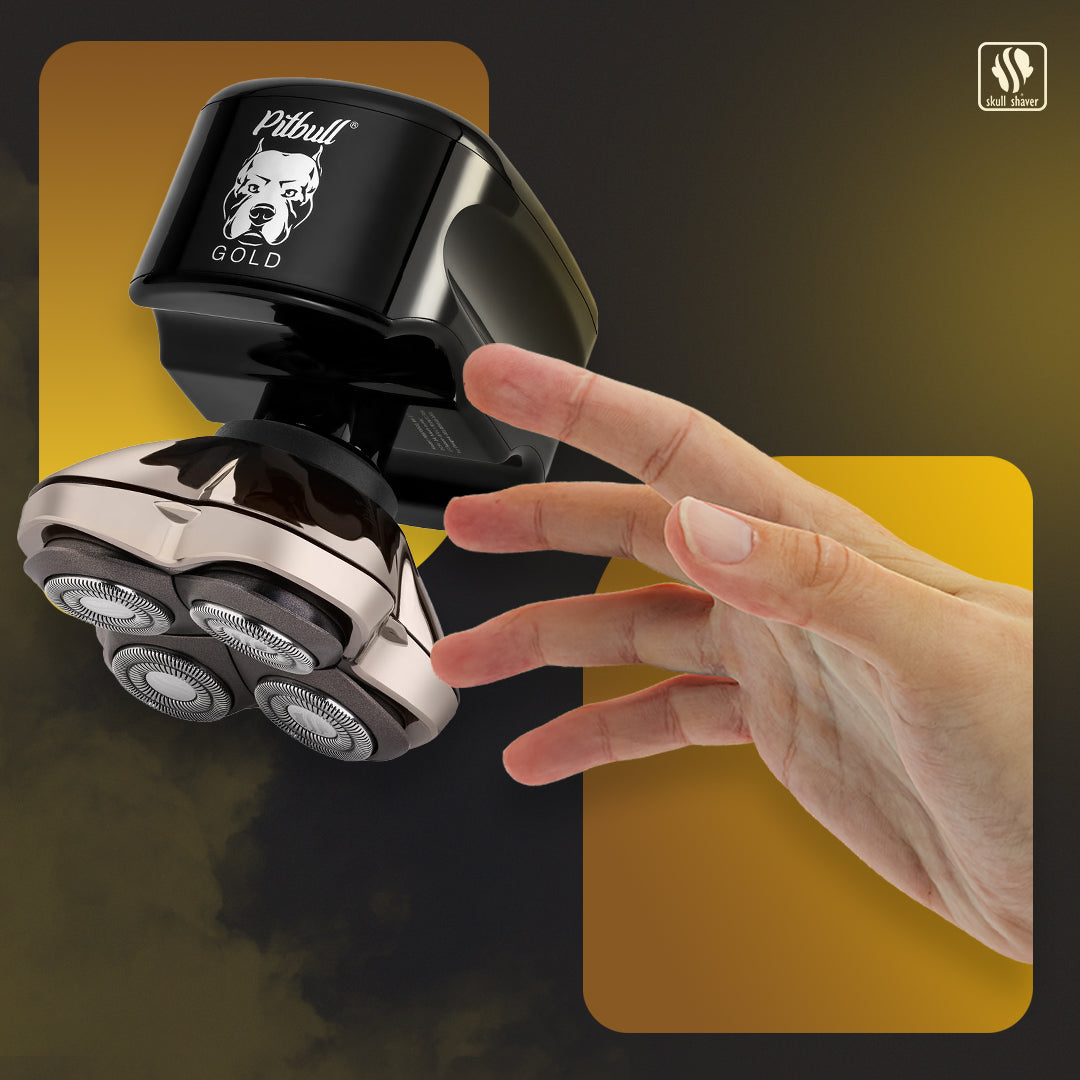 Electric shaver with 'Pitbull Gold Pro GX5' branding held by a hand against a dark background